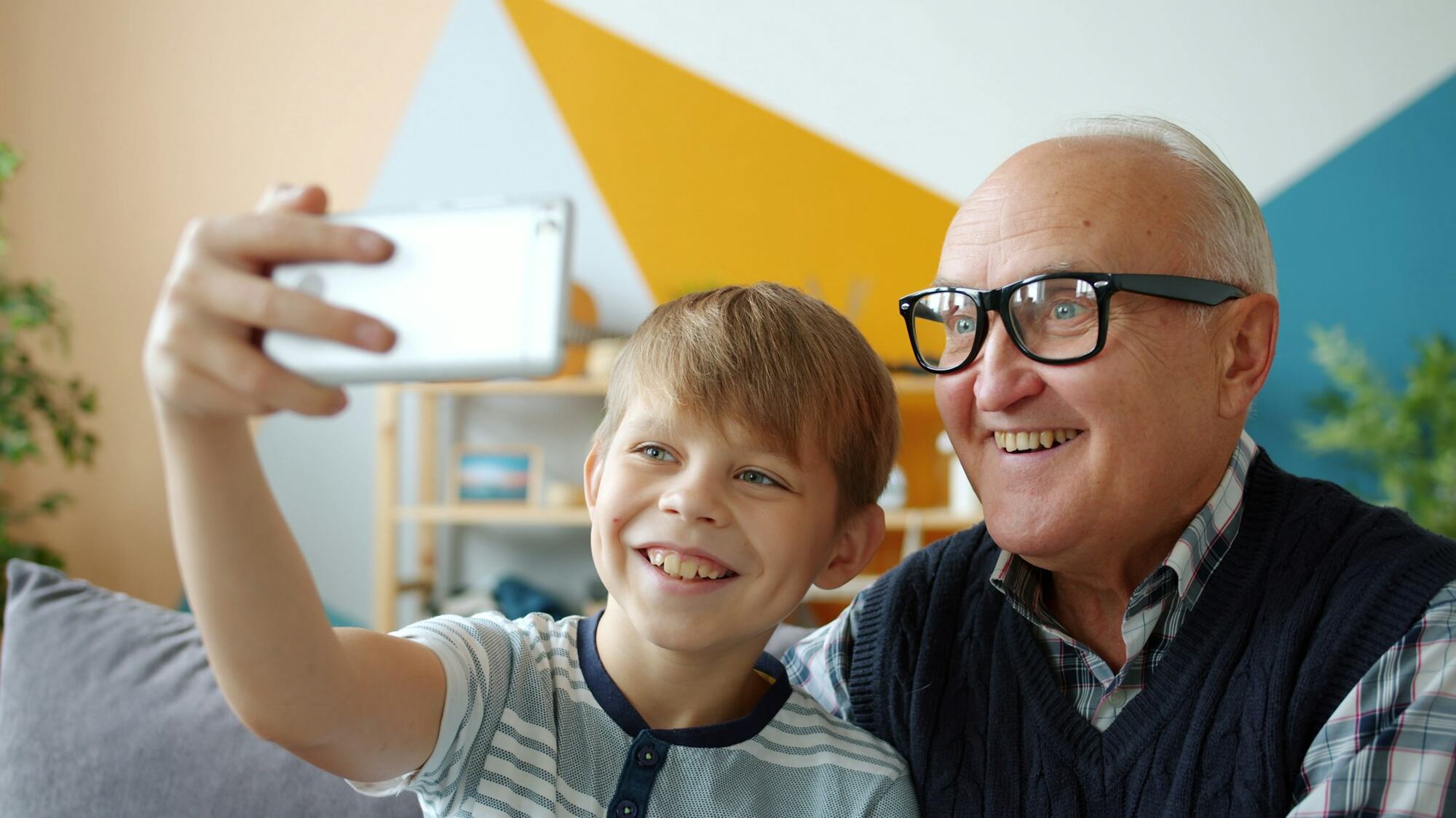 A grandfather and his grandson taking a selfie